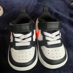 Orange white and black Nikes size 3c new never worn !